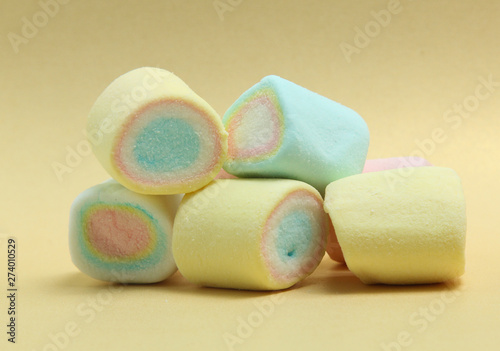 colorful marshmallows candy  on yellow background