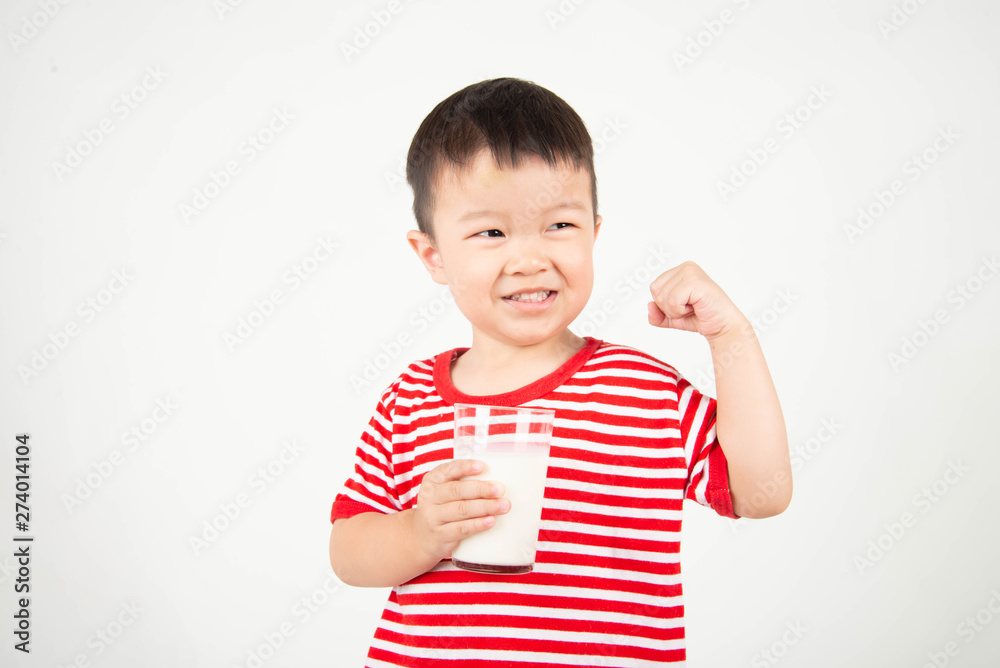 Little Asian boy drinking milk from th glass with happy face Little Asian boy drinking milk from th glass with happy face