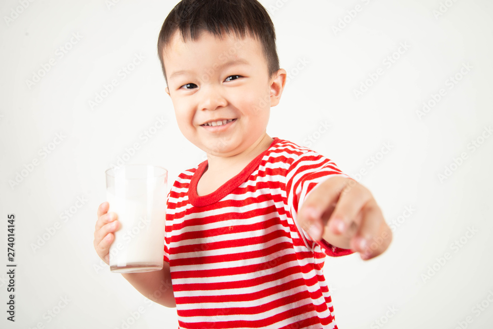 Little Asian boy drinking milk from th glass with happy face Little Asian boy drinking milk from th glass with happy face