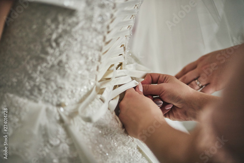 Morning of the bride when she wears a beautiful dress, woman getting ready before wedding ceremony