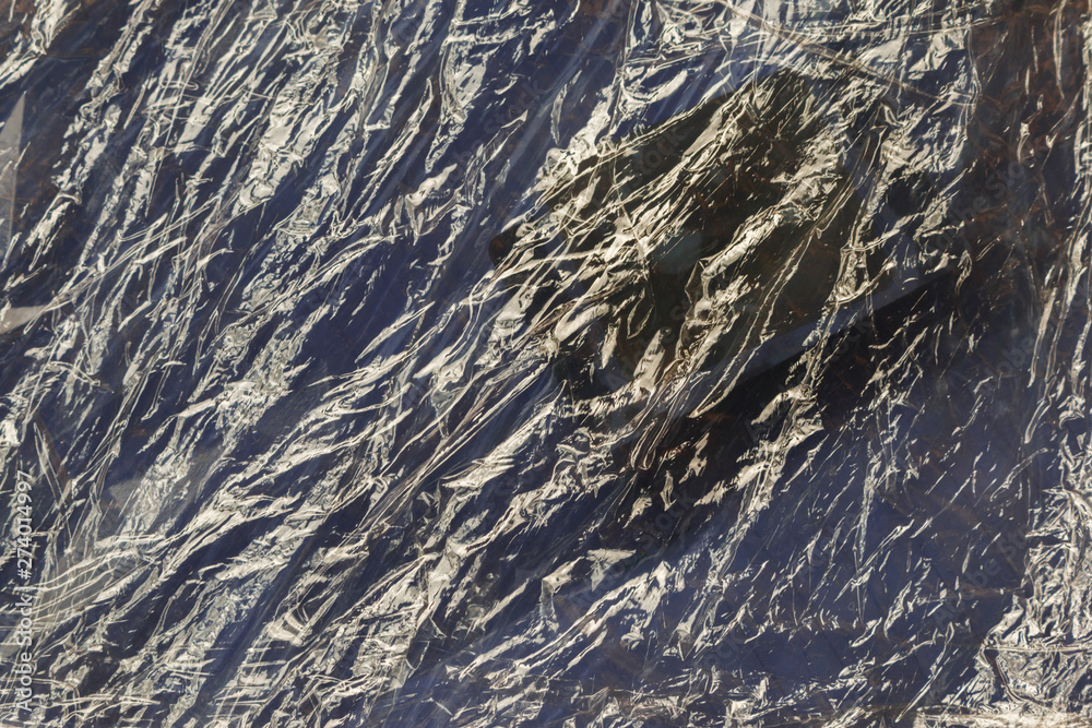 Fototapeta premium Crumpled Plastic wrap texture background for ecological concepts. accumulation in the environment of synthetic plastic products creates problems for wildlife.