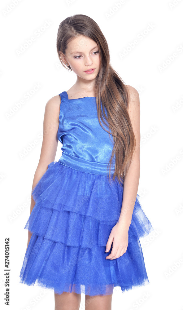 Happy little girl in dress posing on white background