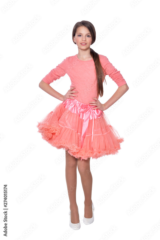 Happy little girl in dress posing on white background