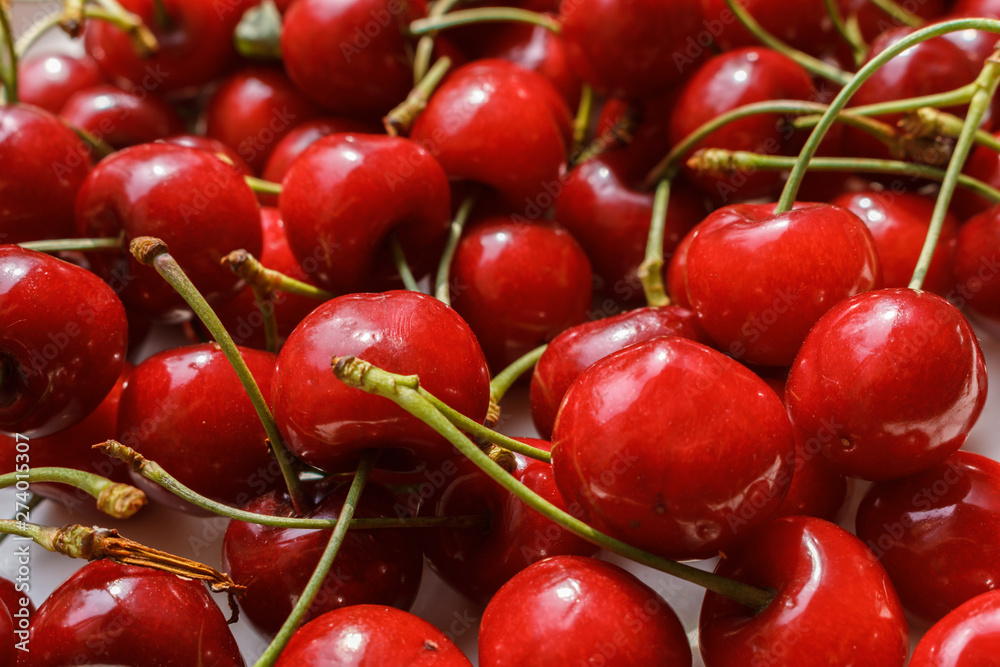 delicious fresh ripe cherries just picked in the garden as background. Fresh red fruits background close-up. delicious fresh ripe cherries just picked in the garden as background. Fresh red fruits background close-up.