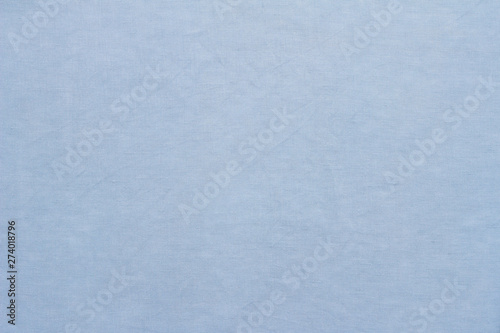 Light blue linen pastel fabric, background or texture, closeup, top view, horizontal
