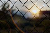 Secure fence at sunset with bokeh. 