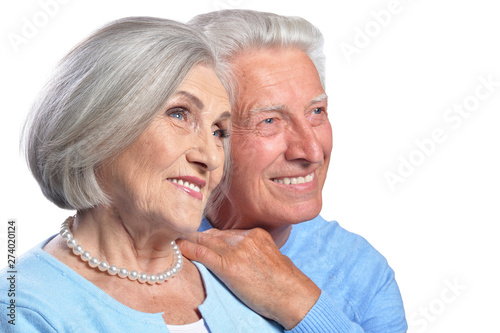 Happy senior couple embracing and posing on white background