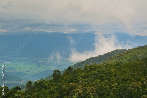 Beautiful landscape view of the mountains with white clouds and sky in the countryside of Thailand. © Aungsumol