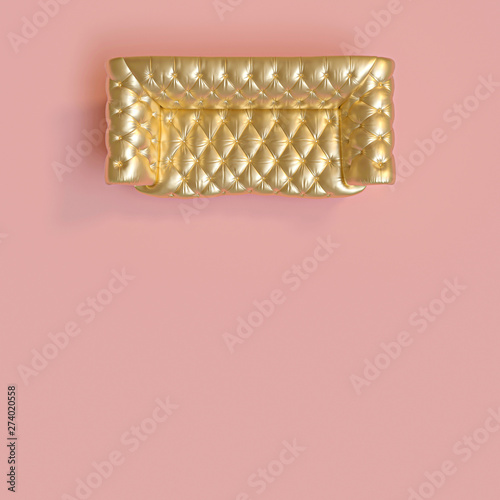 top view of a classic gold-colored tufted sofa on a pink background.