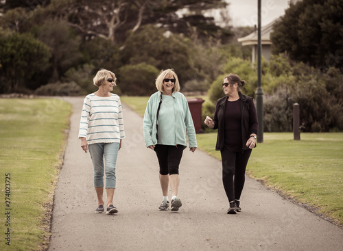 Happy active senior citizen women walking and training together in healthy retirement lifestyle