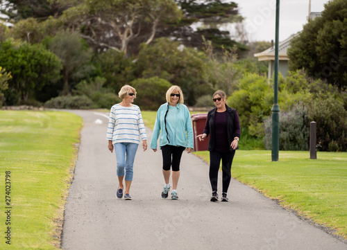 Happy active senior citizen women walking and training together in healthy retirement lifestyle