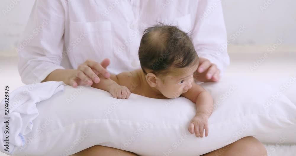Sweet newborn baby lying down on white pillow Sweet newborn baby lying down on white pillow