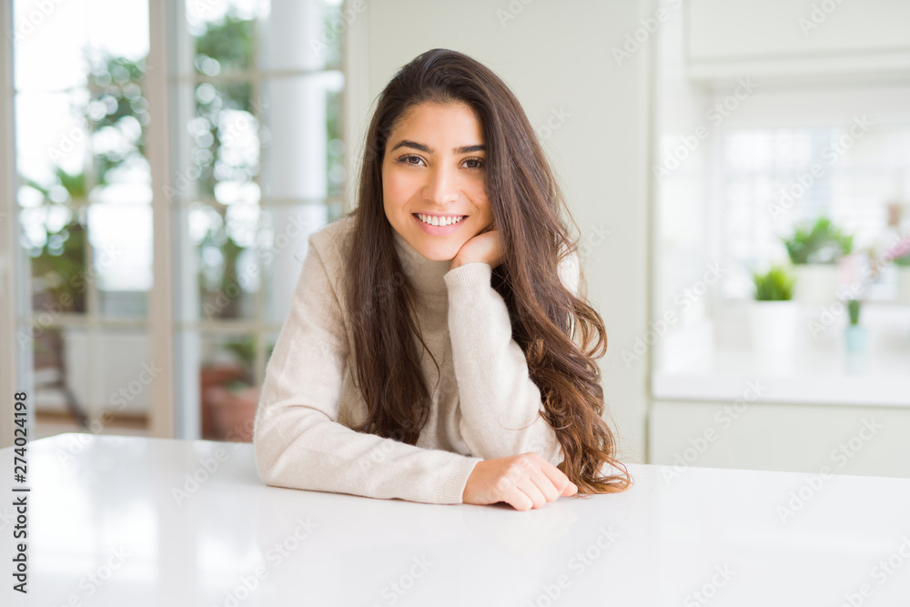 Beautiful brunette woman smiling cheerful with big smile, looking positive and happy with crossed arms Beautiful brunette woman smiling cheerful with big smile, looking positive and happy with crossed arms