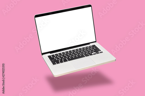 laptop computer mock up with empty blank white screen isolated on pink background. float or levitate laptop notebook with shadow. modern computer technology concept photo