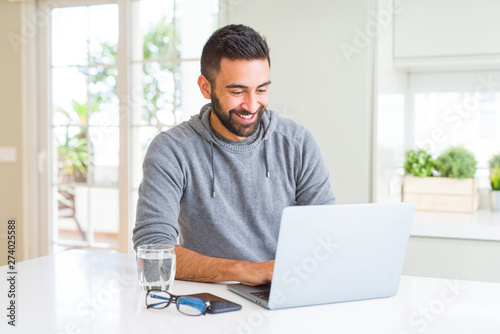 Man smiling working using computer laptop