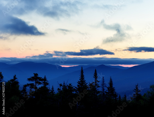 Mountains at sunset covered with dramatic clouds. Wild beautiful USA nature. White Mountain National Park. USA. New Hamshire.