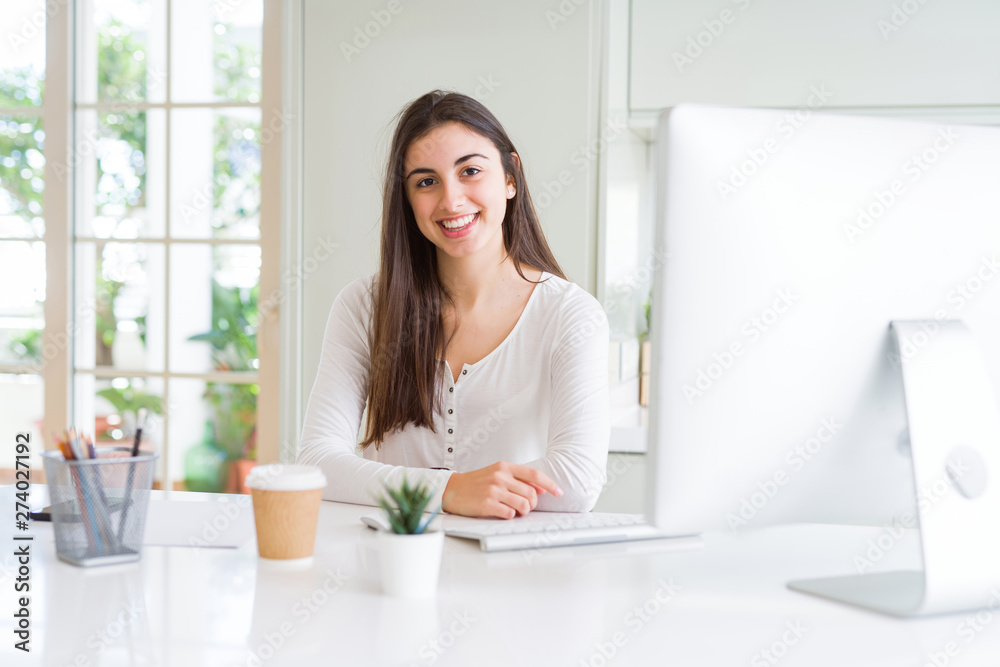 Beautiful young woman working using computer with a happy and cool smile on face. Lucky person. Beautiful young woman working using computer with a happy and cool smile on face. Lucky person.
