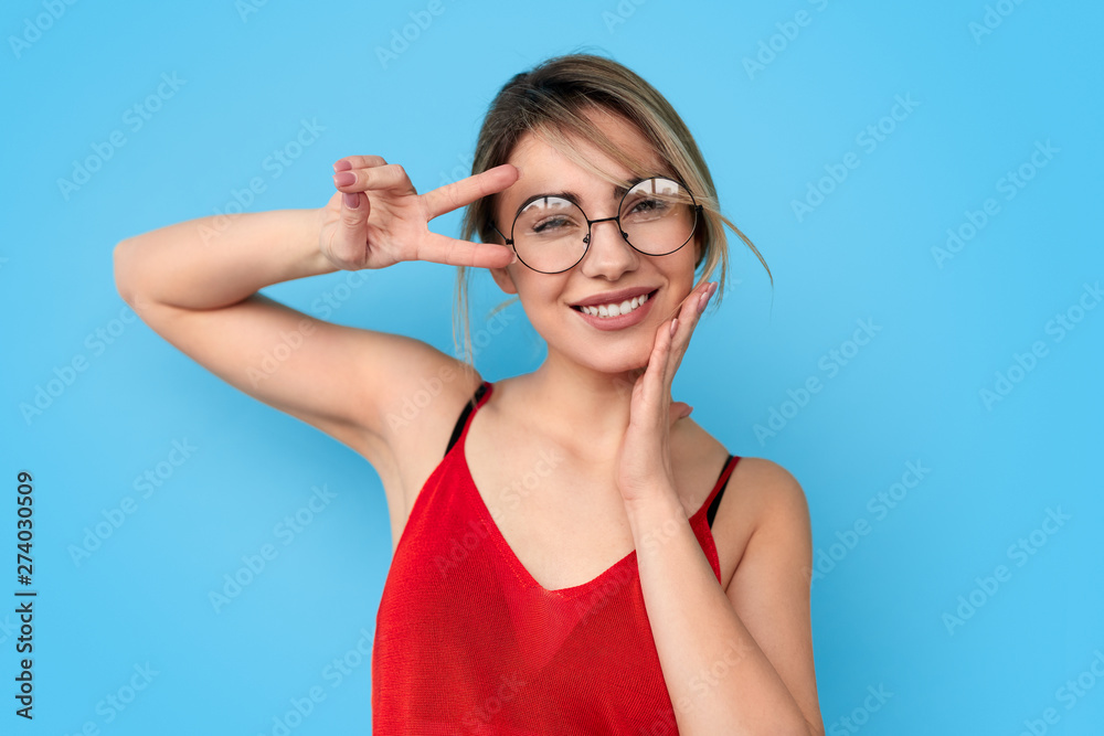 Cheerful young lady gesturing V sign Cheerful young lady gesturing V sign