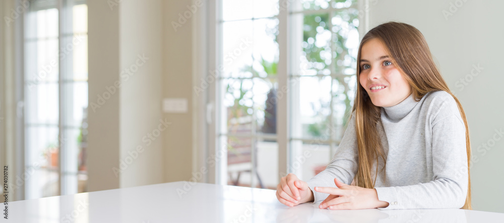Wide angle picture of beautiful young girl kid wearing casual sweater making fish face with lips, crazy and comical gesture. Funny expression. Wide angle picture of beautiful young girl kid wearing casual sweater making fish face with lips, crazy and comical gesture. Funny expression.