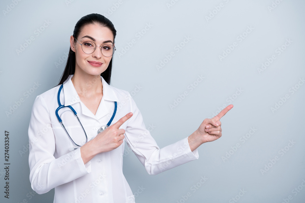 Close up photo beautiful she her lady doctor hospital indicate fingers hands empty space advising use pills wear phonendoscope white science costume specs eyeglasses eyewear isolated grey background