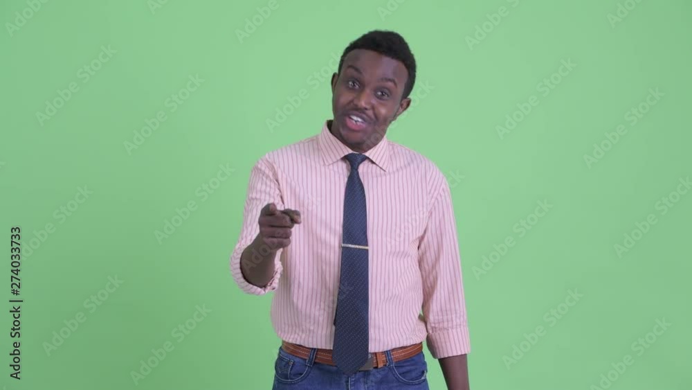 Happy young African businessman pointing to camera and giving thumbs up Happy young African businessman pointing to camera and giving thumbs up