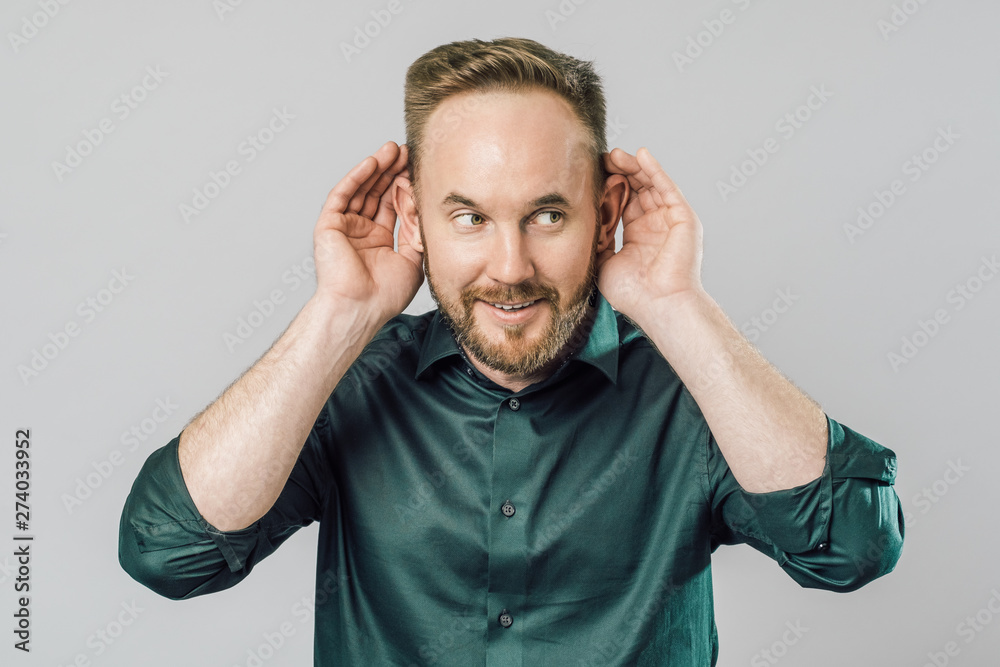 Fototapeta premium Man with hand over ear listening and hearing to rumor or gossip