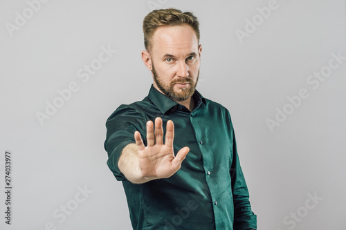 Fototapet Portrait of a serious man showing stop gesture