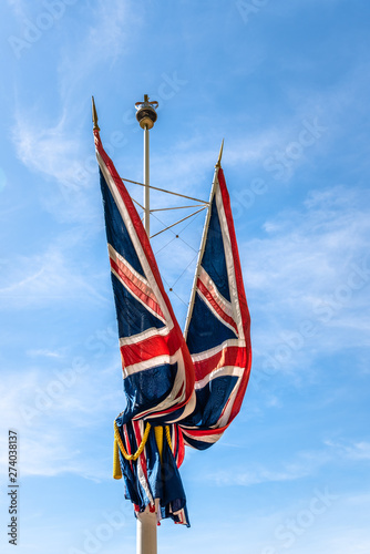 Union Jack flags waving against blue sky