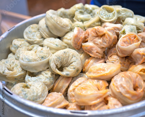 Delicious steamed round shaped dumplings in South Korea traditional market  special korean street food cuisine  close up  bokeh  copy space