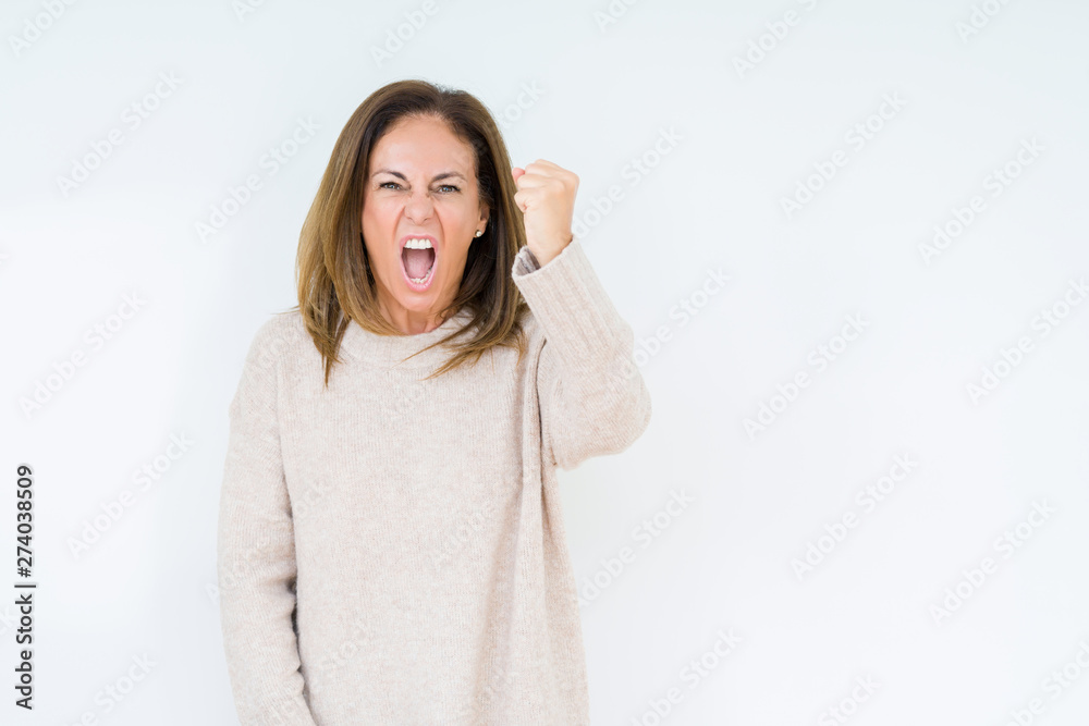 Beautiful middle age woman over isolated background angry and mad raising fist frustrated and furious while shouting with anger. Rage and aggressive concept. Beautiful middle age woman over isolated background angry and mad raising fist frustrated and furious while shouting with anger. Rage and aggressive concept.