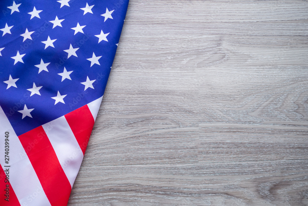 Fototapeta premium American flag on a wooden table background. Space for text