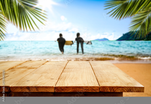 Summer desk of free space and surfers on beach. Summer time and ocean landscape  #274040125