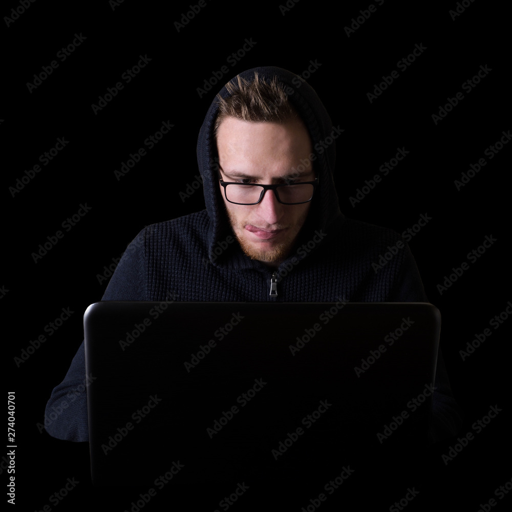 Hacker,programmer on glases in front of his computer, with laptop initiating cyber attack, isolated on black backgroung Hacker,programmer on glases in front of his computer, with laptop initiating cyber attack, isolated on black backgroung