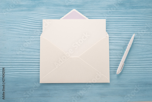  White envelope and pen on a blue background 