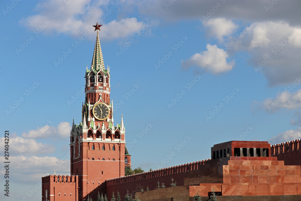 View to the Kremlin and Lenin mausoleum on Red Square in Moscow. Spasskaya tower against the blue sky with clouds, russian landmarks
