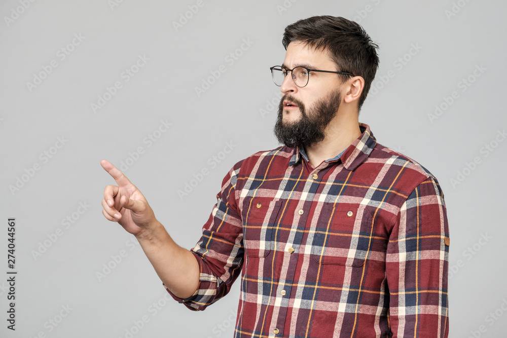 Beautiful bearded guy pointing aside