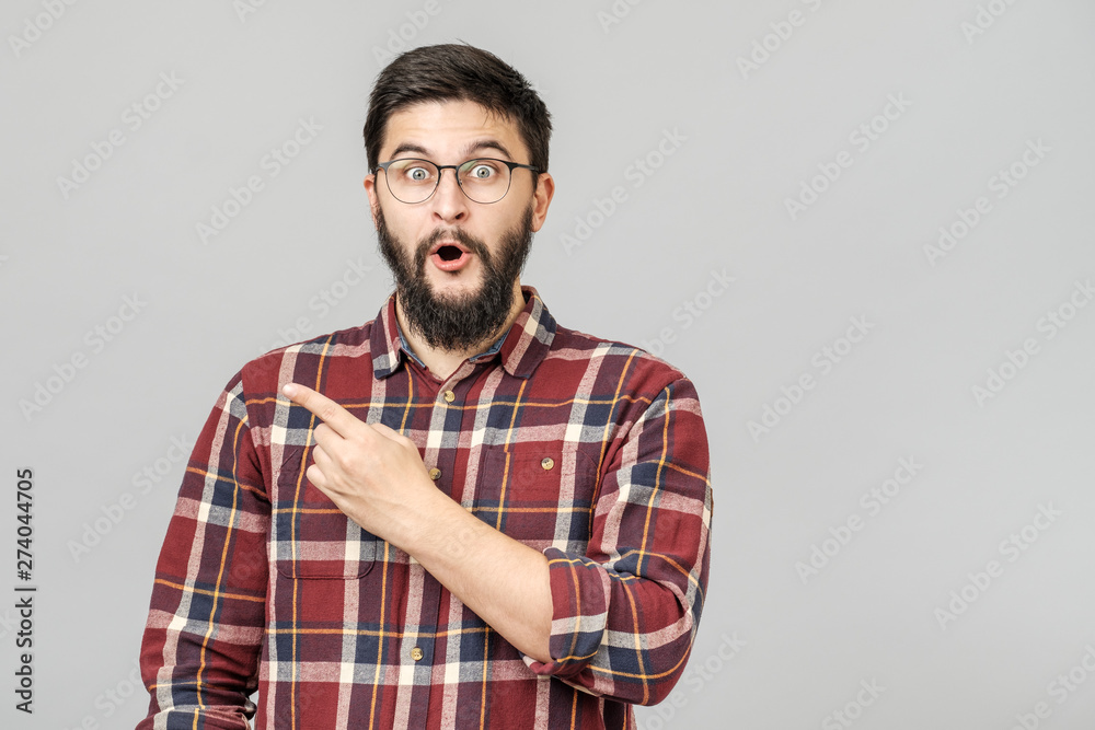 Thrilled excited guy in glasses isolated over gray Thrilled excited guy in glasses isolated over gray