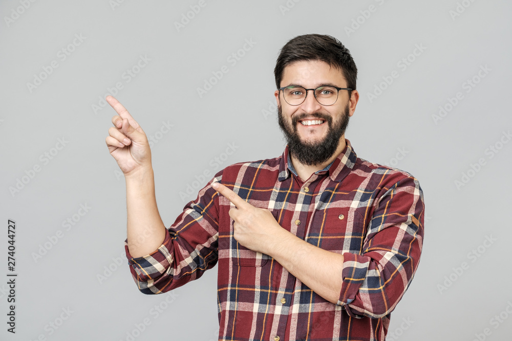 Beautiful bearded guy pointing aside