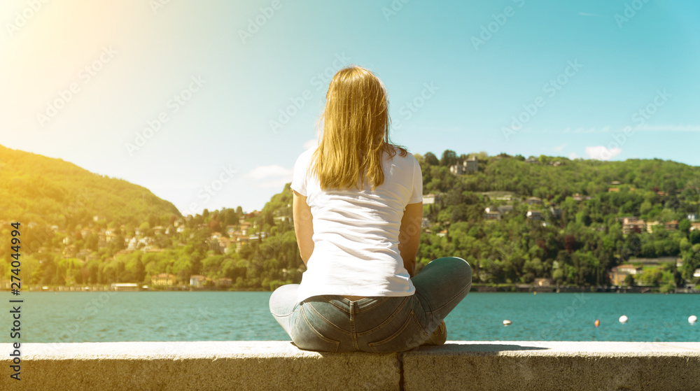 Woman resting near the lake Como in Italy.