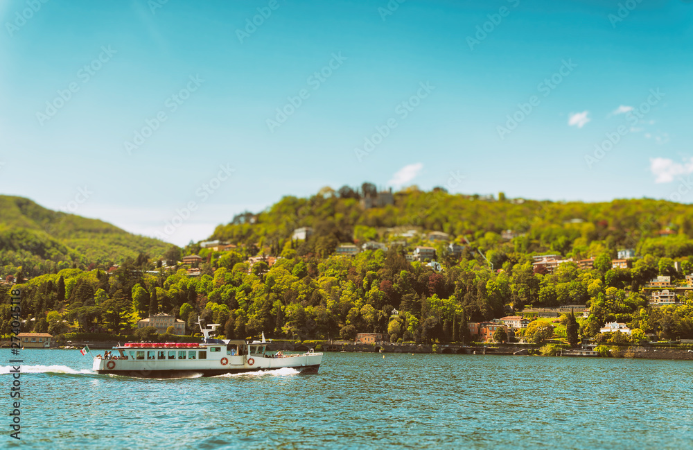 Small excursion boat floating on the Como lake in Italy.