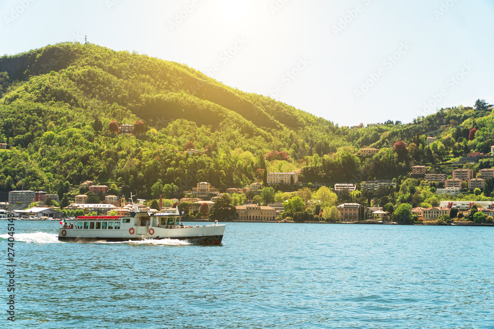 Fototapeta premium Small excursion boat floating on the Como lake in Italy.
