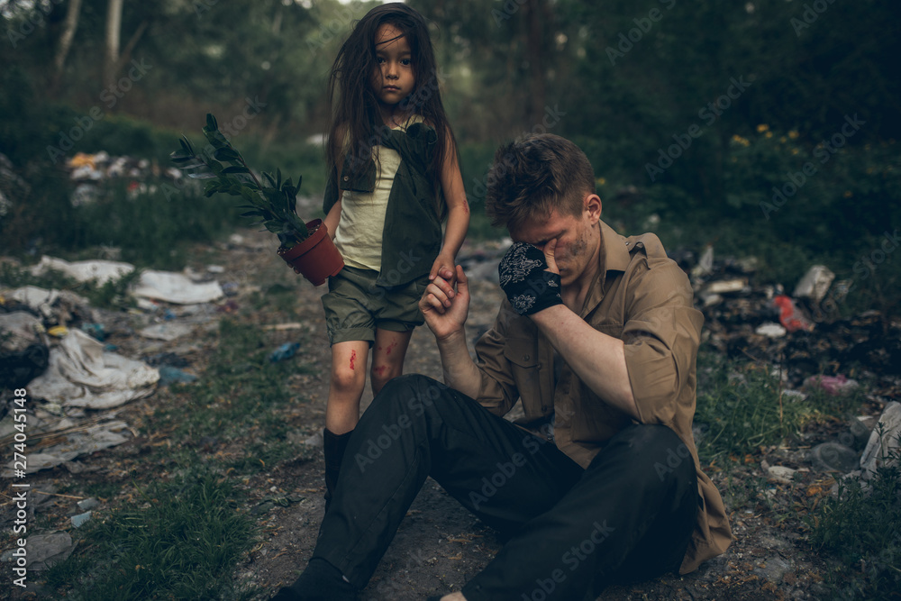 Homeless crying father and daughter are in garbage dump. Homeless crying father and daughter are in garbage dump.