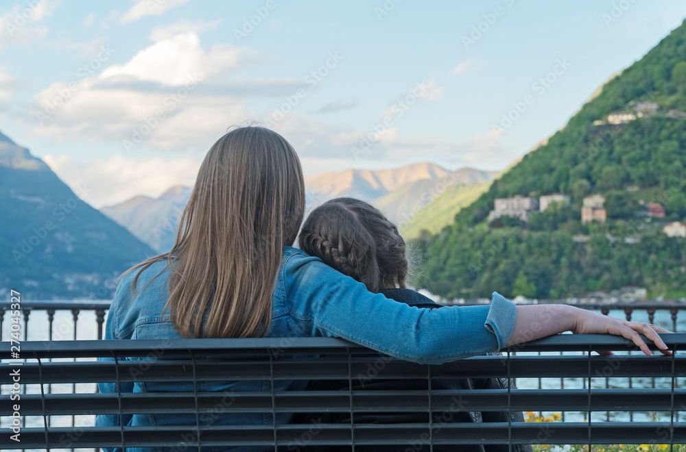 Woman and her daughter resting near the lake Como.