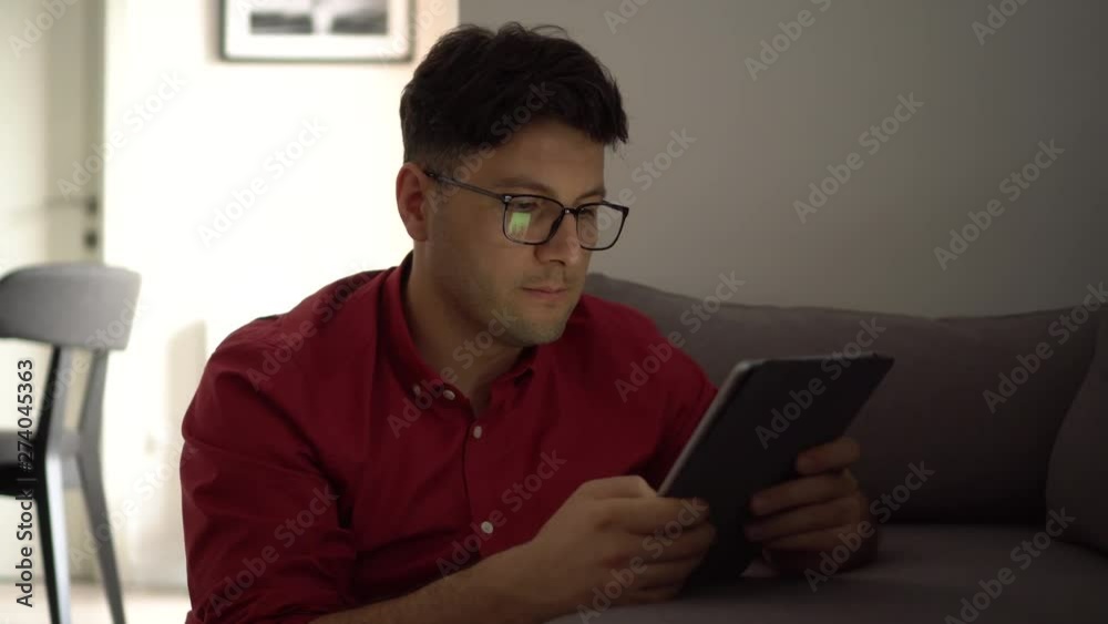 Young man looking at digital tablet Young man looking at digital tablet