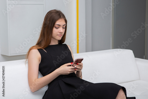 Young female agent speaking to client on the phone in office