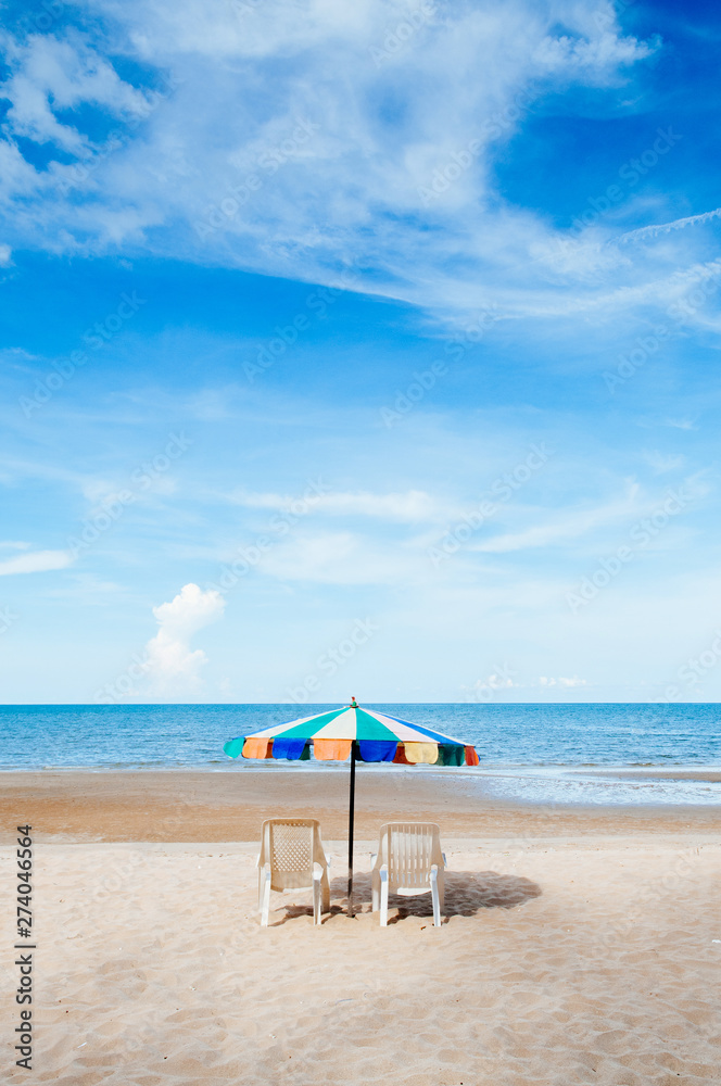 Beach beds and colourful umbrella with ocean horizon view and clear sky slightly clouds in summer Beach beds and colourful umbrella with ocean horizon view and clear sky slightly clouds in summer