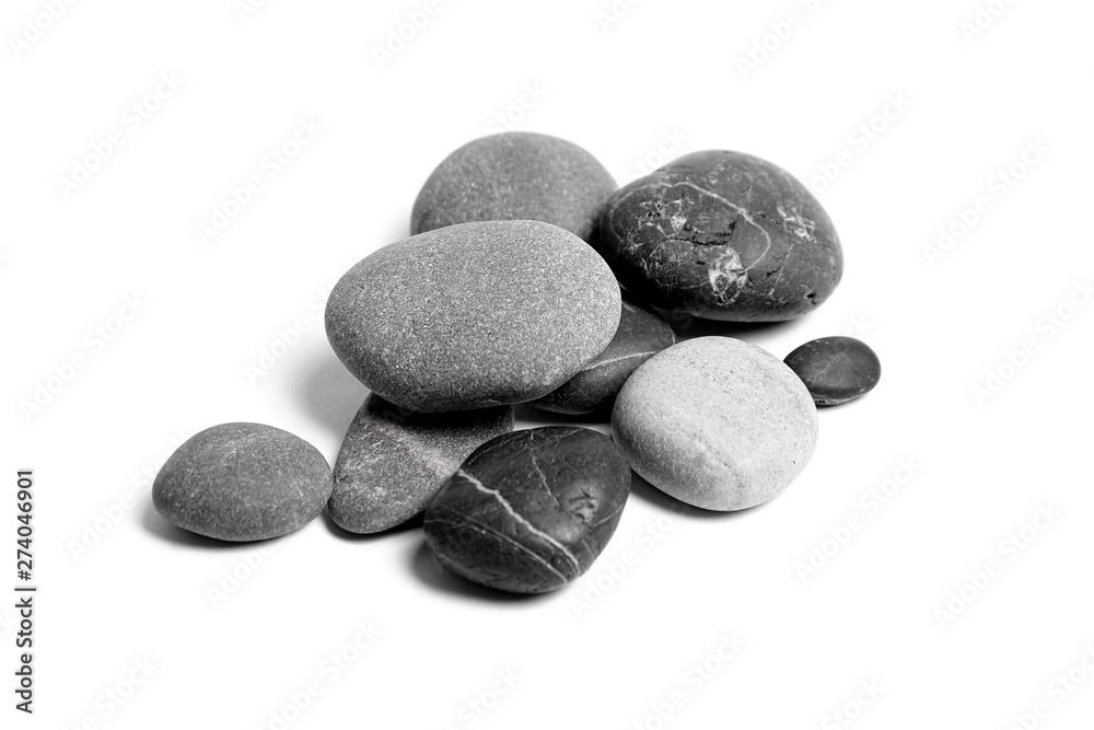 Scattered sea pebbles. Heap of smooth gray and black stones isolated on white background. Rounded rocks Scattered sea pebbles. Heap of smooth gray and black stones isolated on white background. Rounded rocks