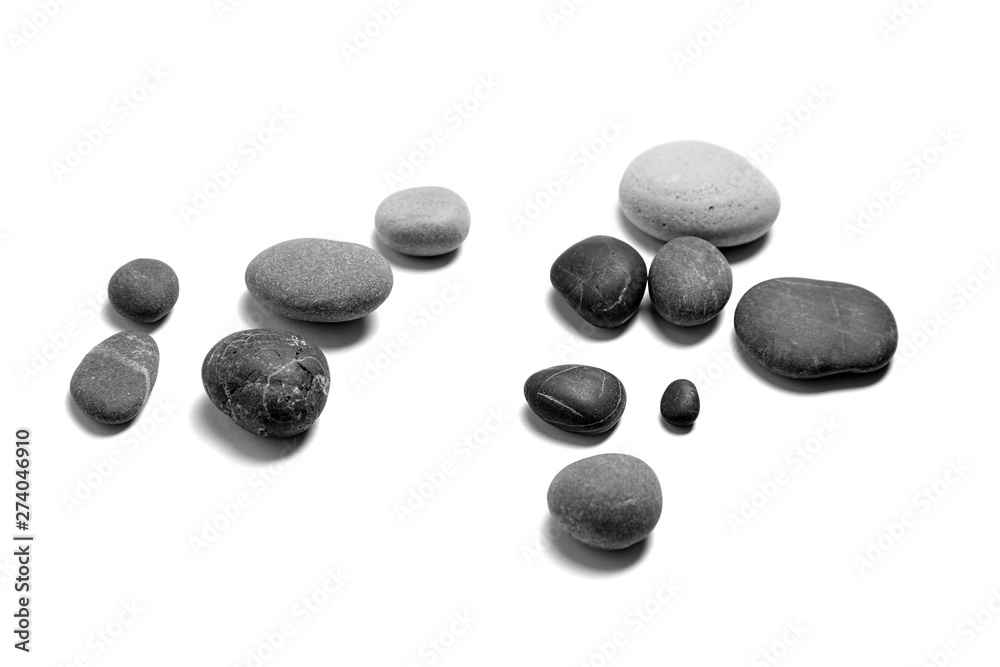 Scattered sea pebbles. Heap of smooth gray and black stones isolated on white background. Rounded rocks Scattered sea pebbles. Heap of smooth gray and black stones isolated on white background. Rounded rocks