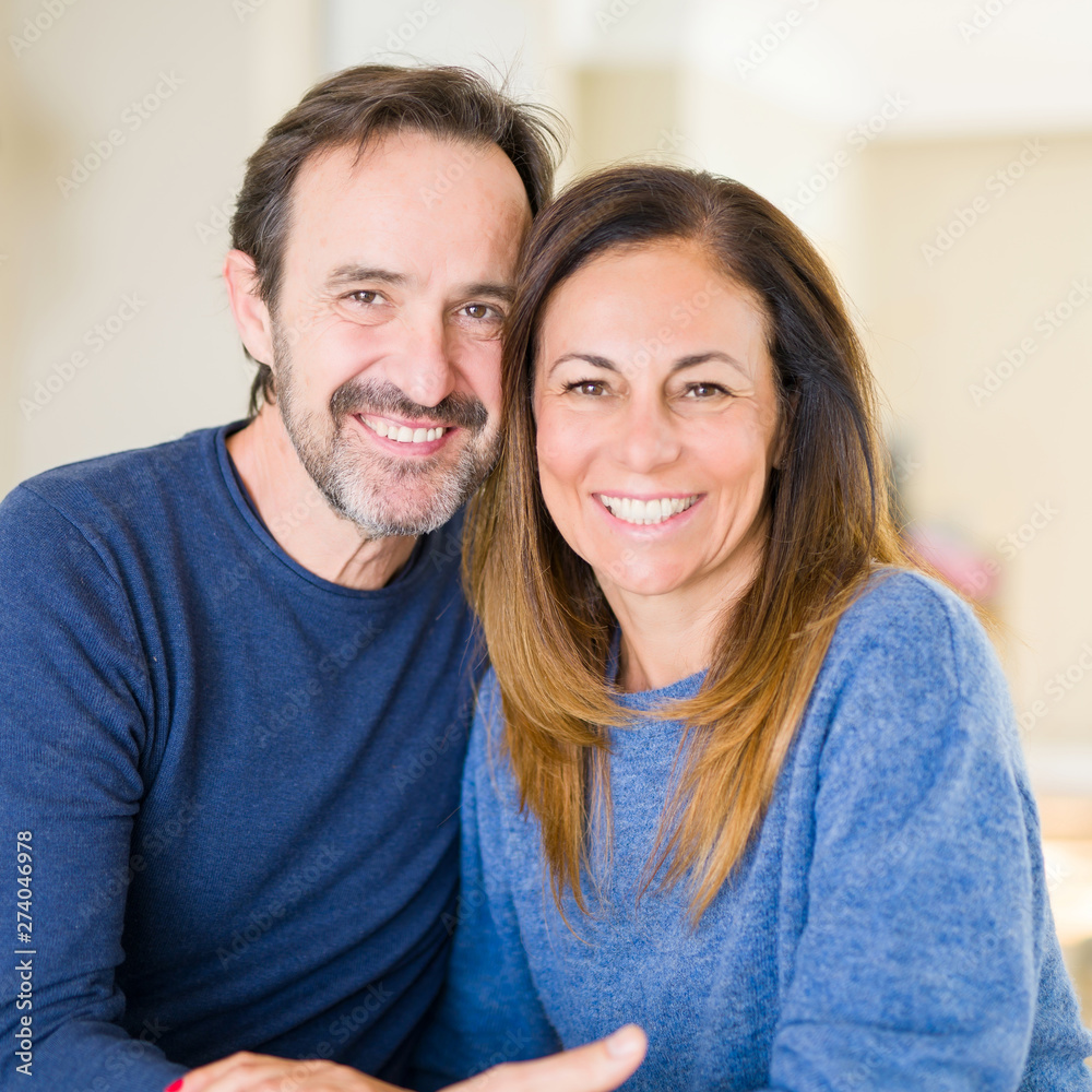 Obraz premium Romantic middle age couple sitting together at home