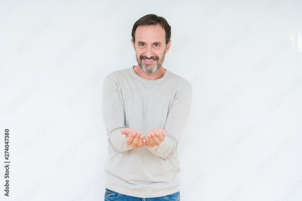 Elegant senior man over isolated background Smiling with hands palms together receiving or giving gesture. Hold and protection Elegant senior man over isolated background Smiling with hands palms together receiving or giving gesture. Hold and protection